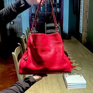 used red Coach handbag nearly perfect except small pen mark inside
$300 new